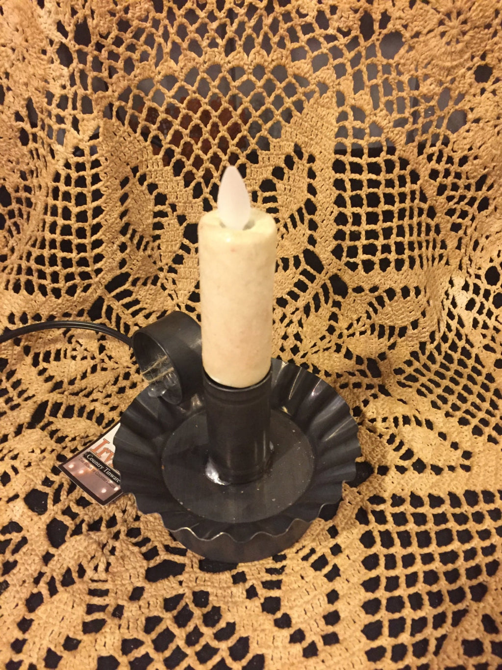 Moving flame bulb plug in tin ware