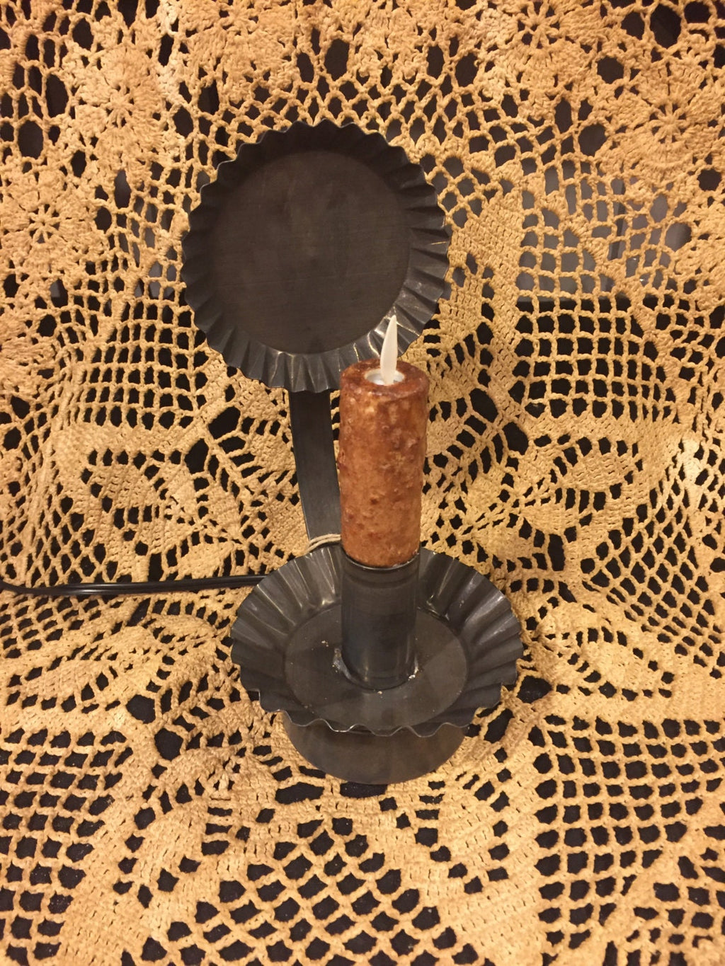 Moving flame bulb plug in tin ware reflector
