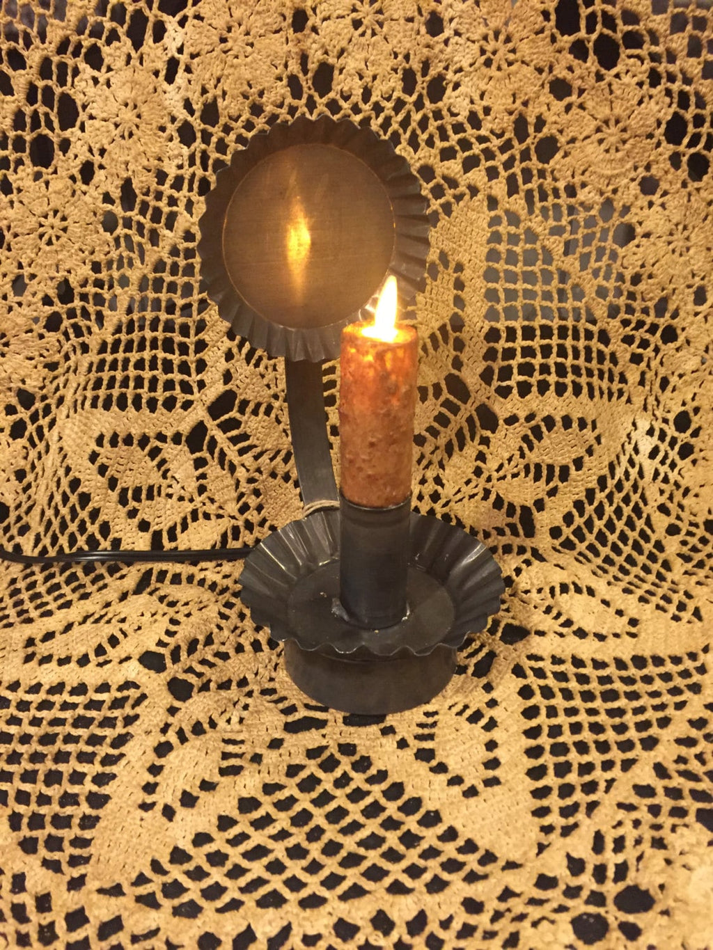 Moving flame bulb plug in tin ware reflector